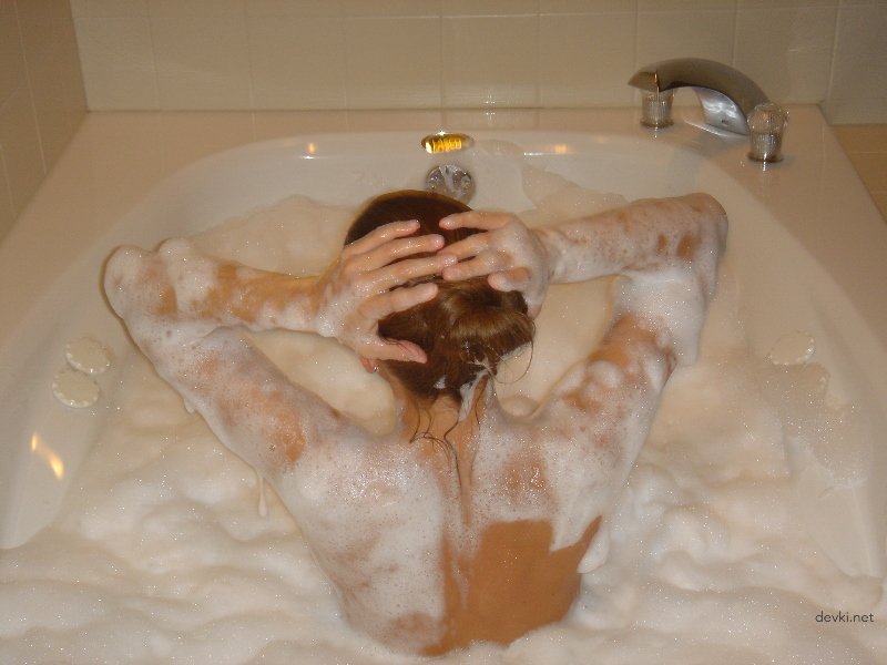 Steamy Bath Time: Seductive Woman Taking a Soothing Bubble Bath