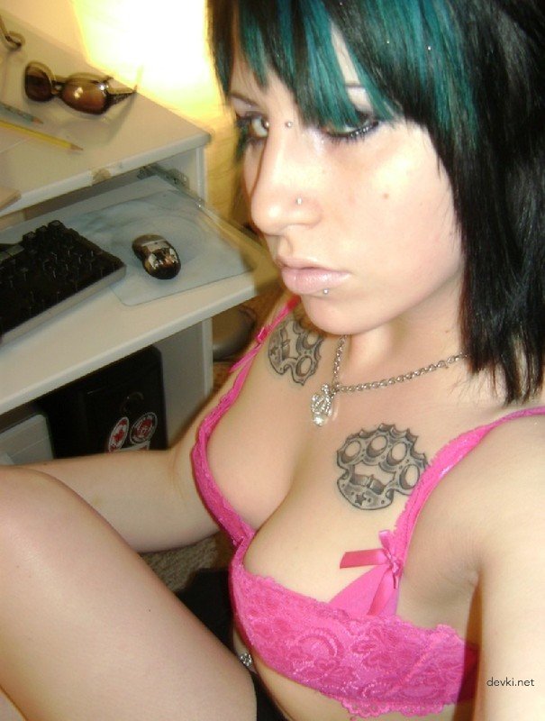 Sexy Young Woman with Piercings and Tattoos: Hot and Edgy Look