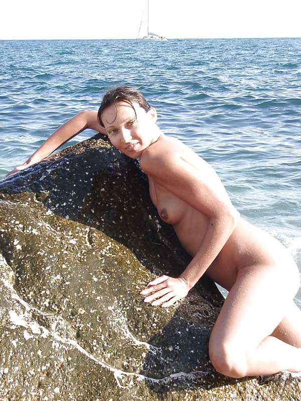 Naked girl sunbathing at the beach - Explicit and daring seaside relaxation