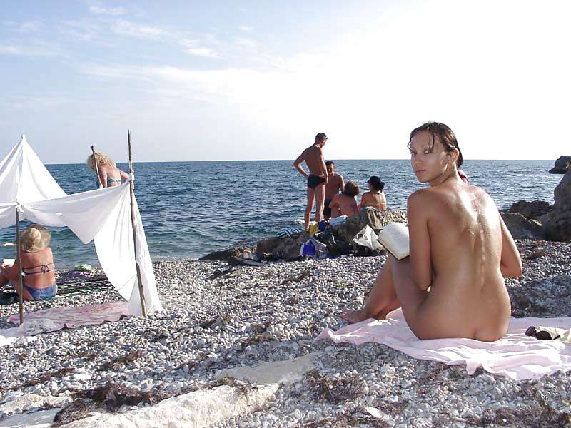 Naked girl sunbathing at the beach - Explicit and daring seaside relaxation
