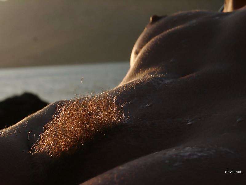 Naked girl sunbathing at the beach - Explicit and daring seaside relaxation