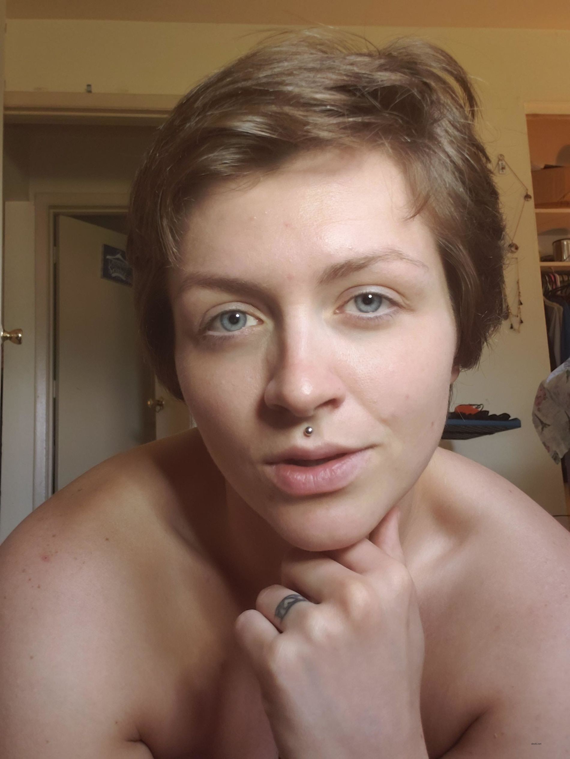 Naked Woman with Piercing Poses Explicitly: Sensual Body Art Display