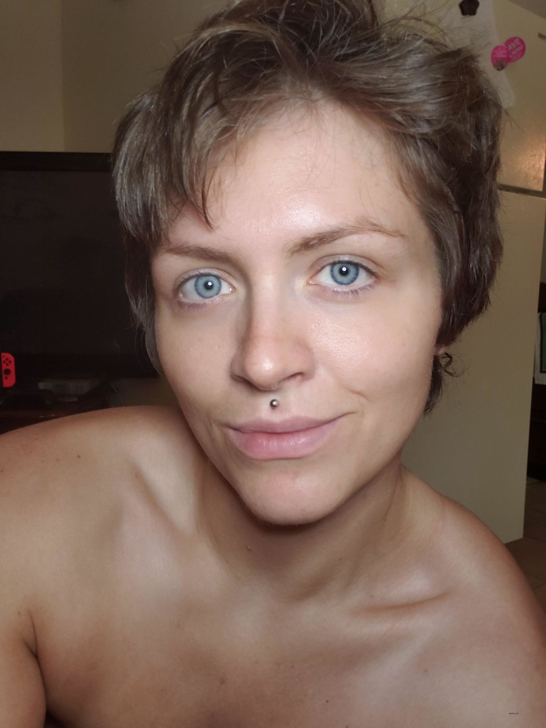 Naked Woman with Piercing Poses Explicitly: Sensual Body Art Display