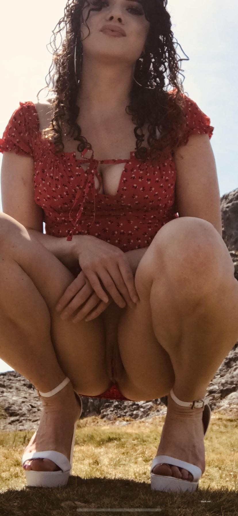 Sultry Dark-Haired Curly Beauty Exposing All in Provocative Pose