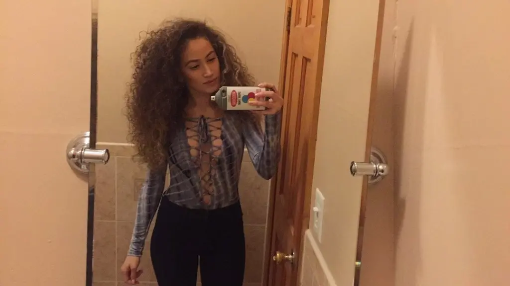 Curly-haired selfie girl flaunts her breasts in explicit photo