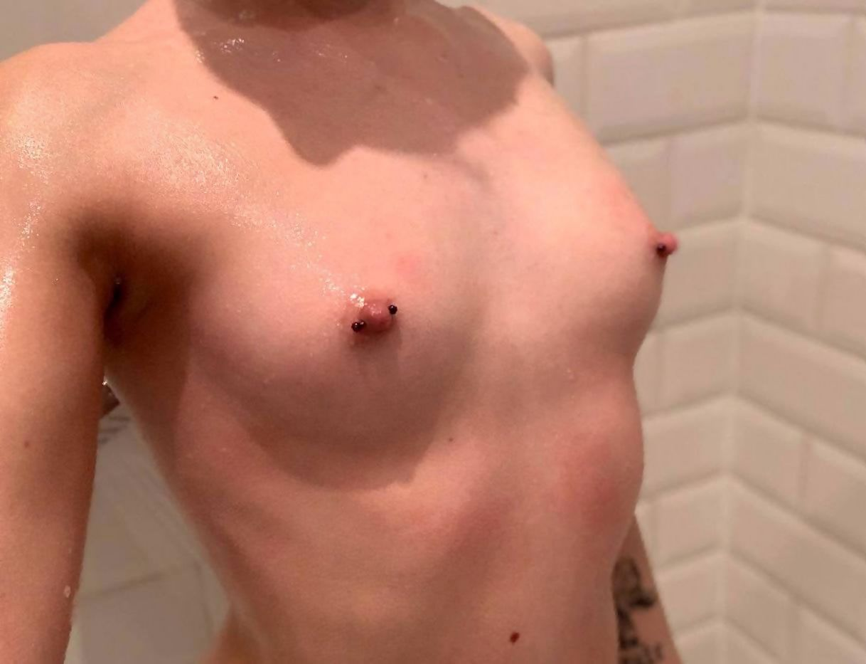 Explicit Intimate Photos of Young Girl with Tattoos and Nipple Piercings