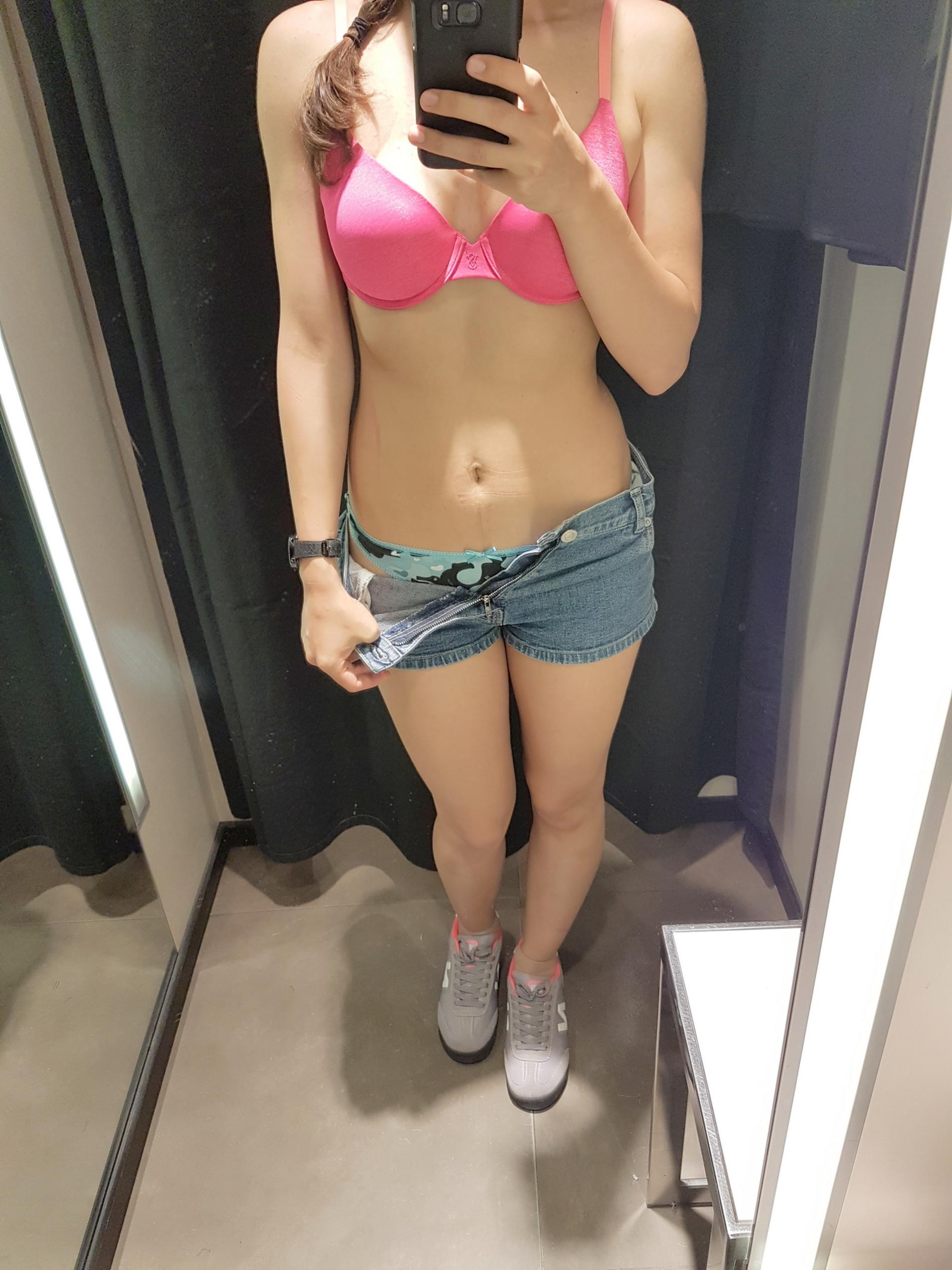 Spying in the mirror, I took off my shorts and showed off my wet panties and aroused pussy