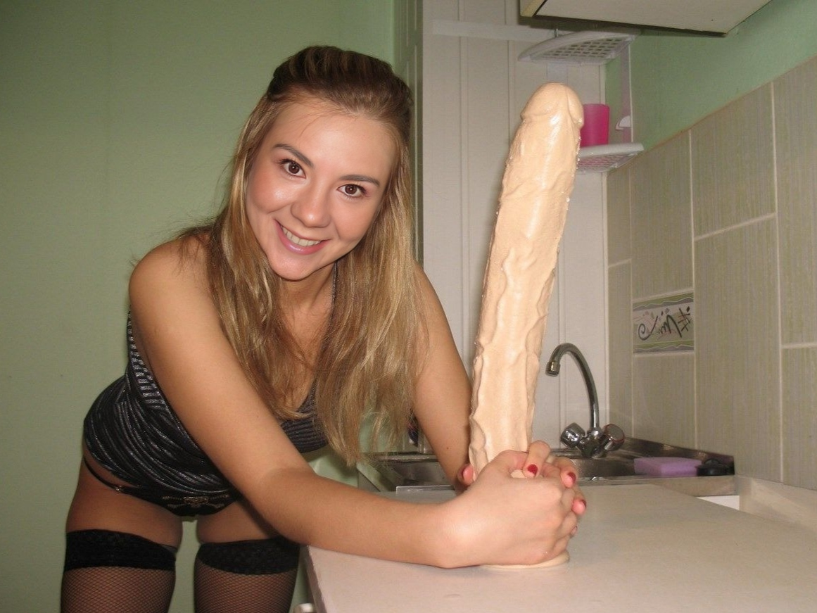 Young woman tests her limits with massive sex toy and enjoys every inch