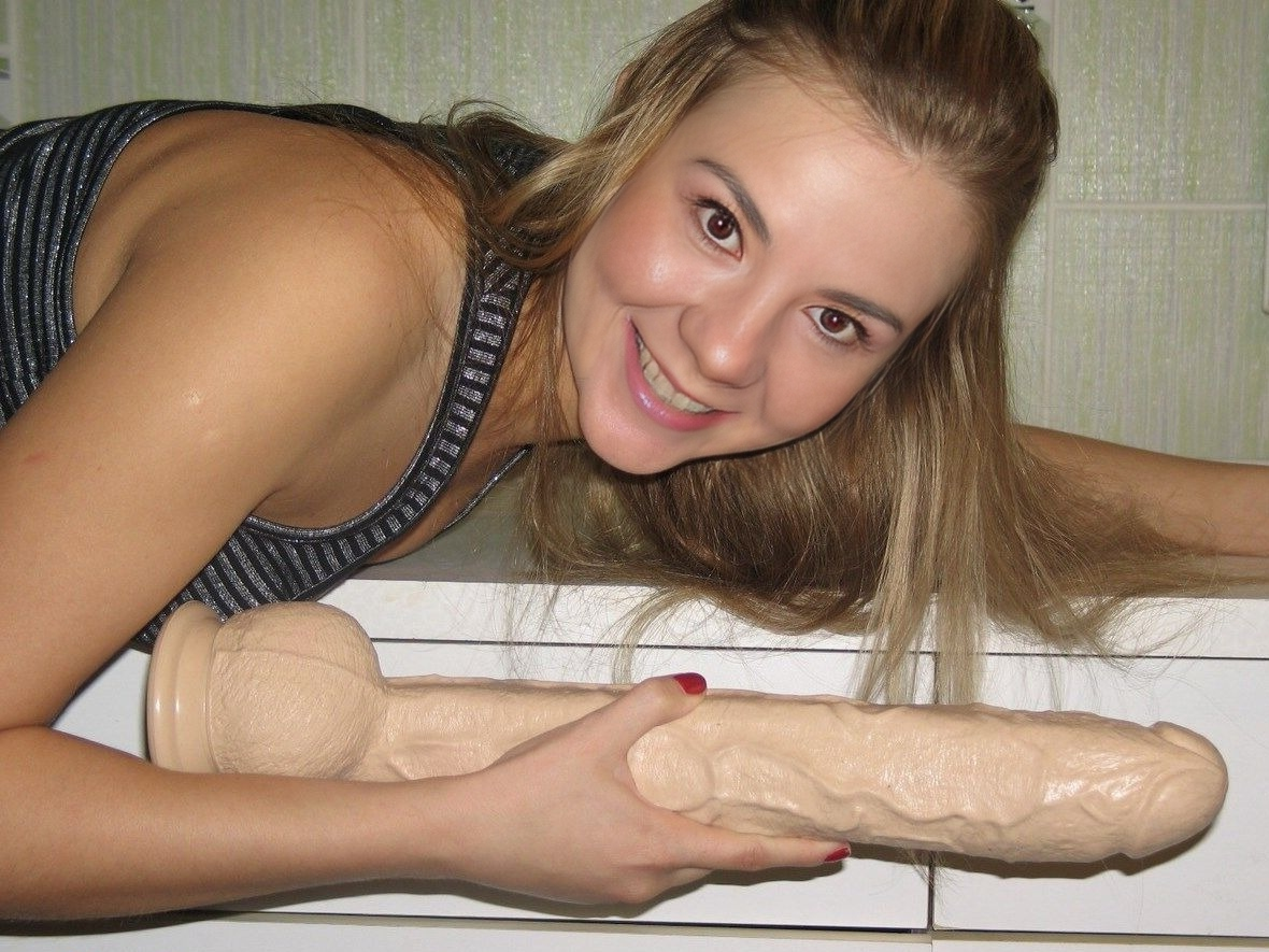 Young woman tests her limits with massive sex toy and enjoys every inch