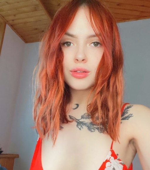 Seductive Redhead Girl Flaunting Attractive Body in Front of Camera