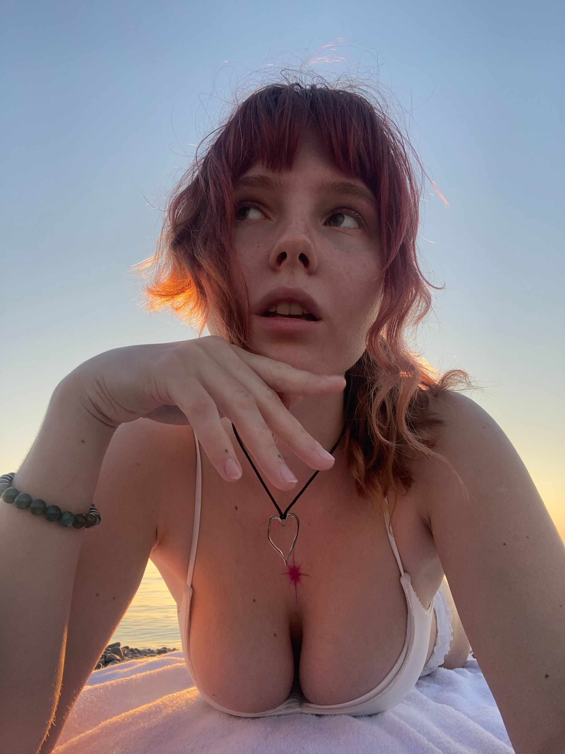 Redhead beauty with big tits loves posing naked outdoors