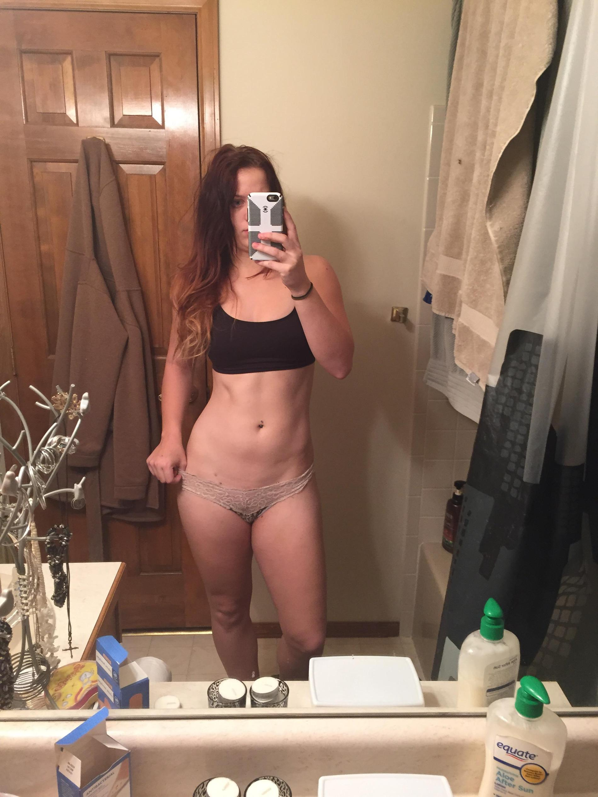 Sexy Girl Takes Selfie, Admiring Her Figure in Mirror