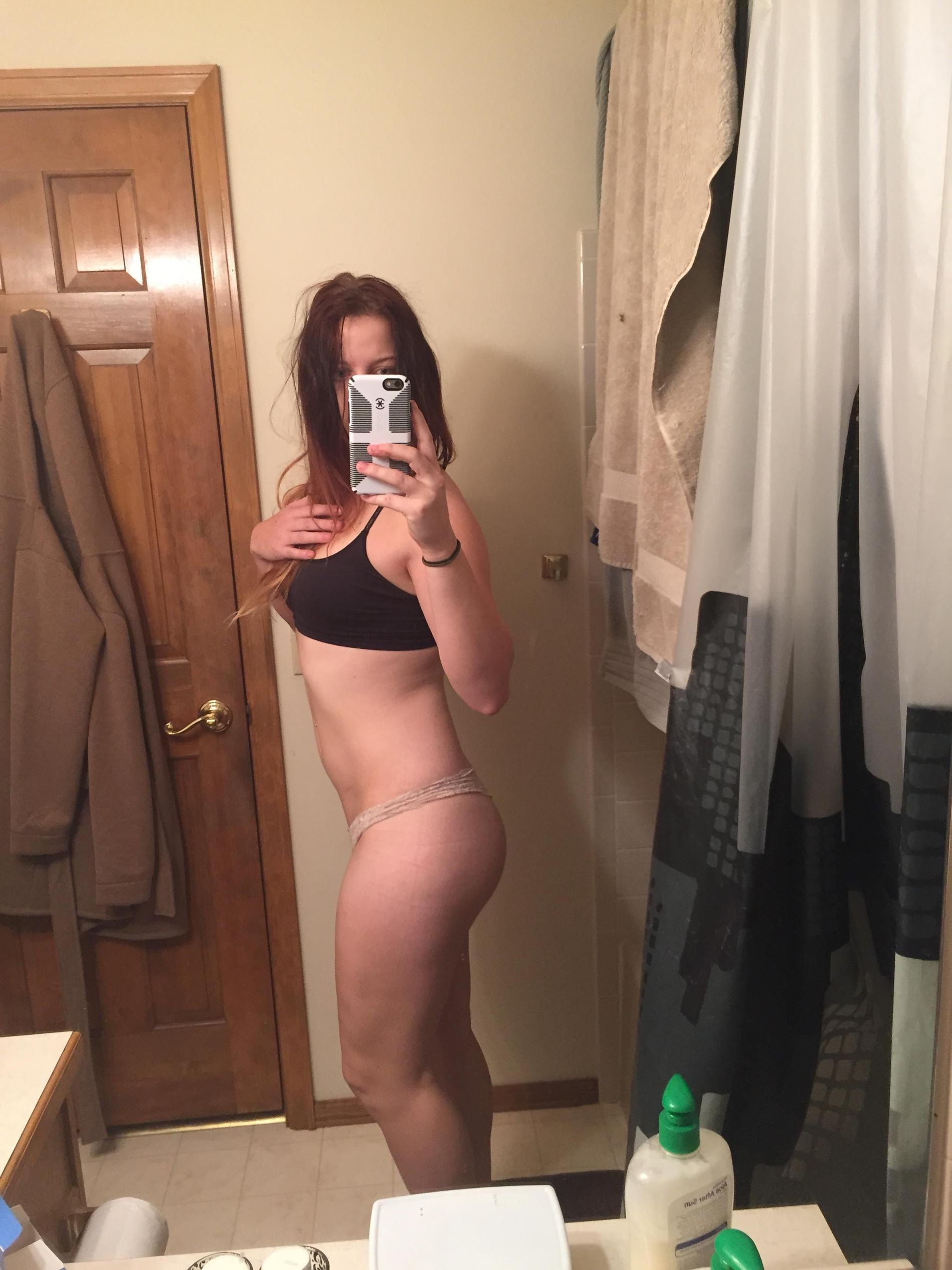 Sexy Girl Takes Selfie, Admiring Her Figure in Mirror