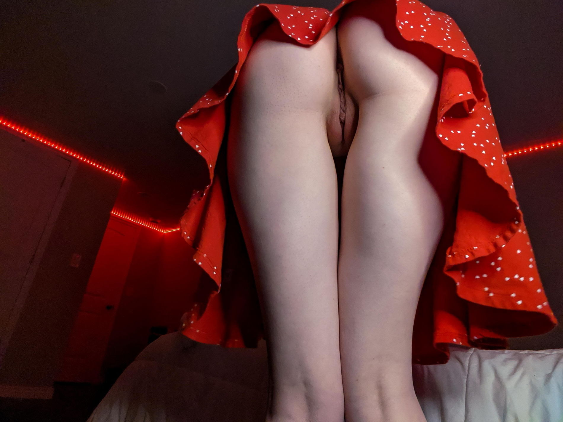 Seductive redhead babe takes sultry selfie in dimly lit room mirror