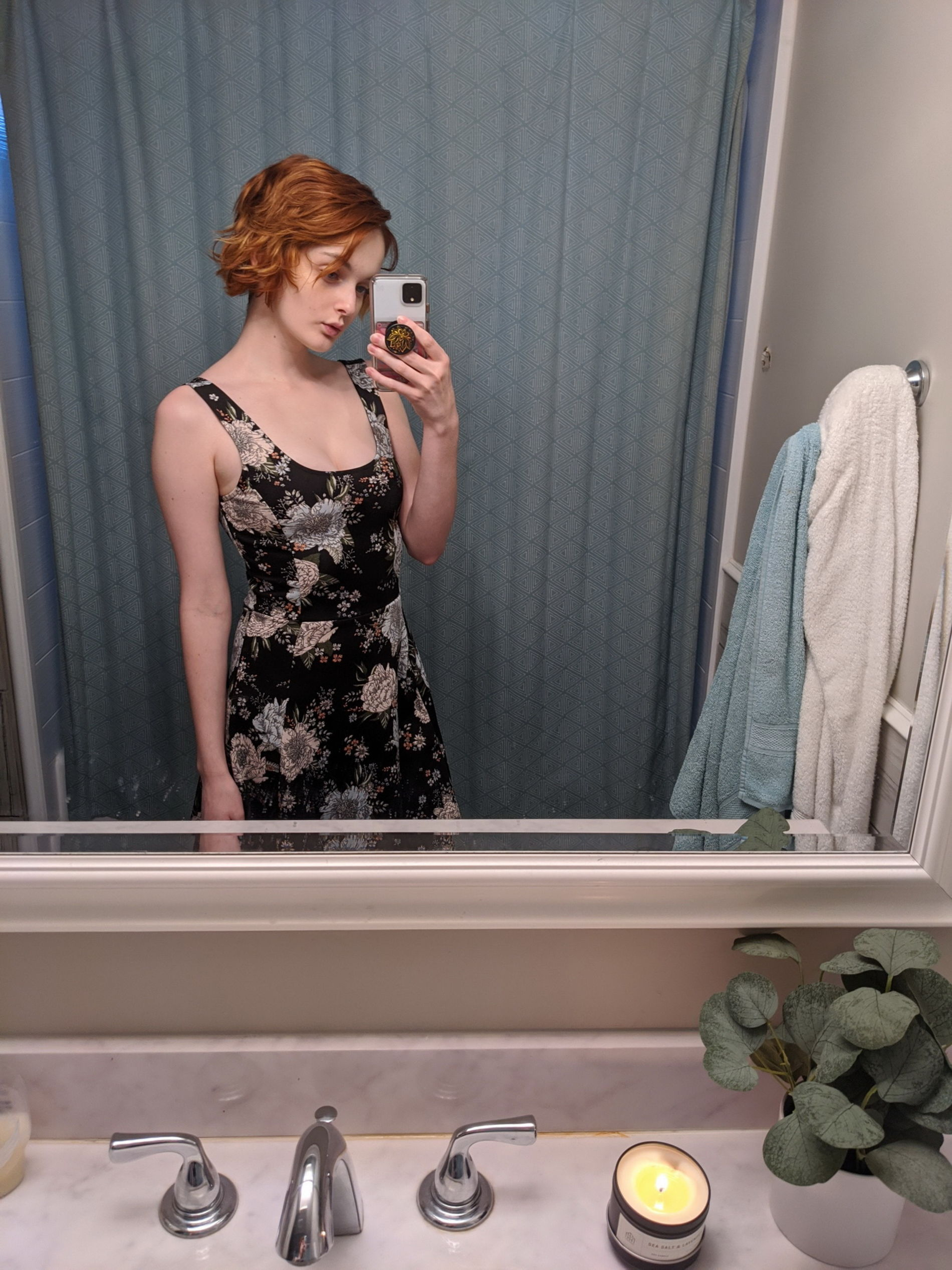 Seductive redhead babe takes sultry selfie in dimly lit room mirror