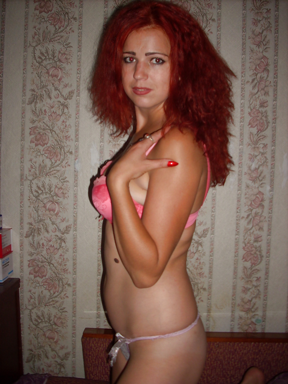 Seductive redhead woman flaunts her stunning body