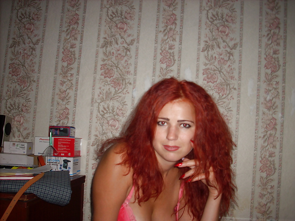 Seductive redhead woman flaunts her stunning body