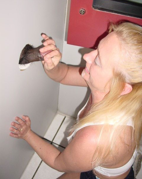 Horny woman gives blowjobs through gloryhole to multiple men