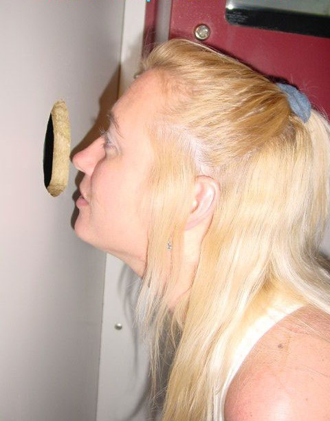 Horny woman gives blowjobs through gloryhole to multiple men