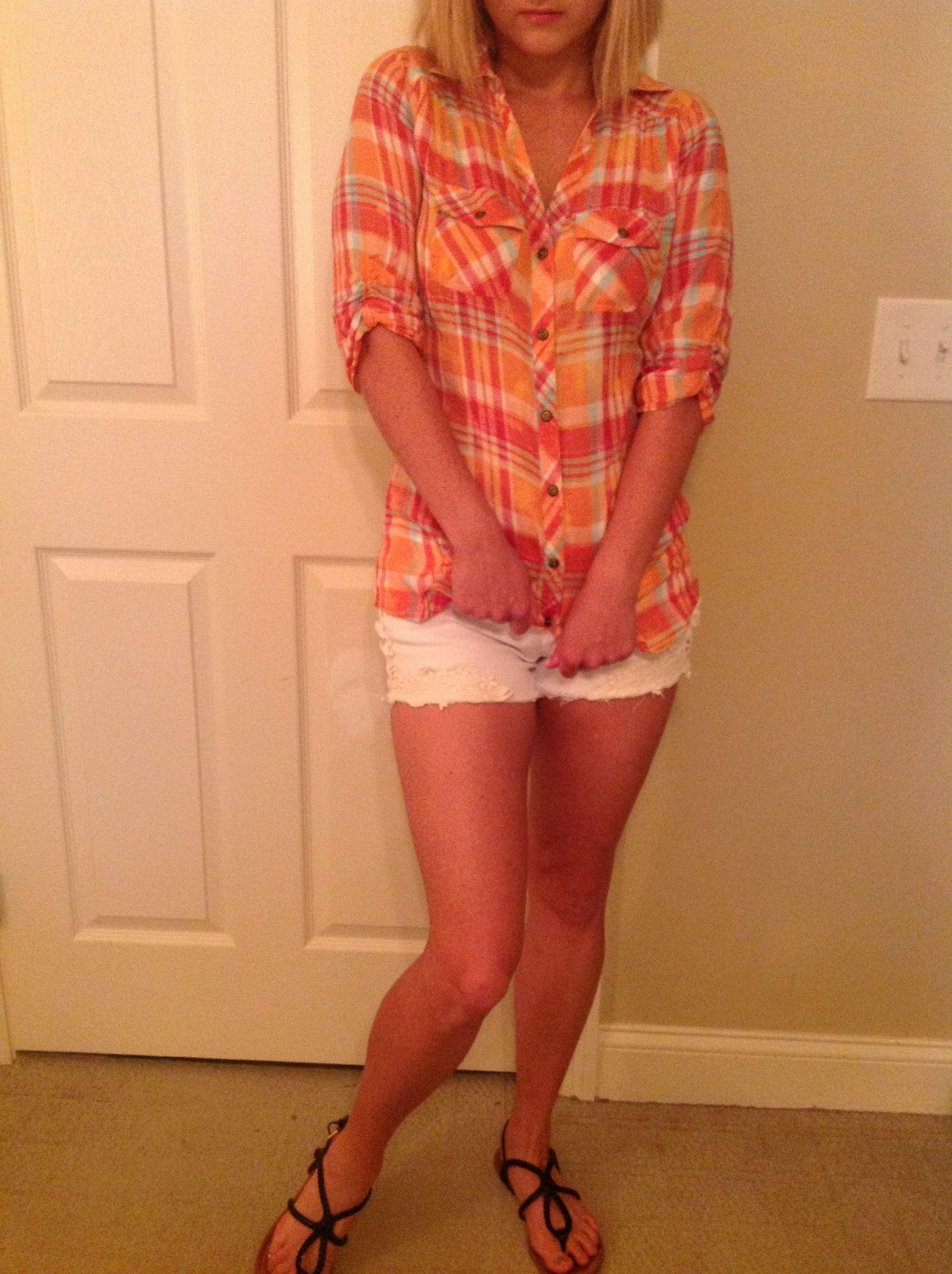 Girl strips to reveal body in white shorts and plaid shirt – photo 1