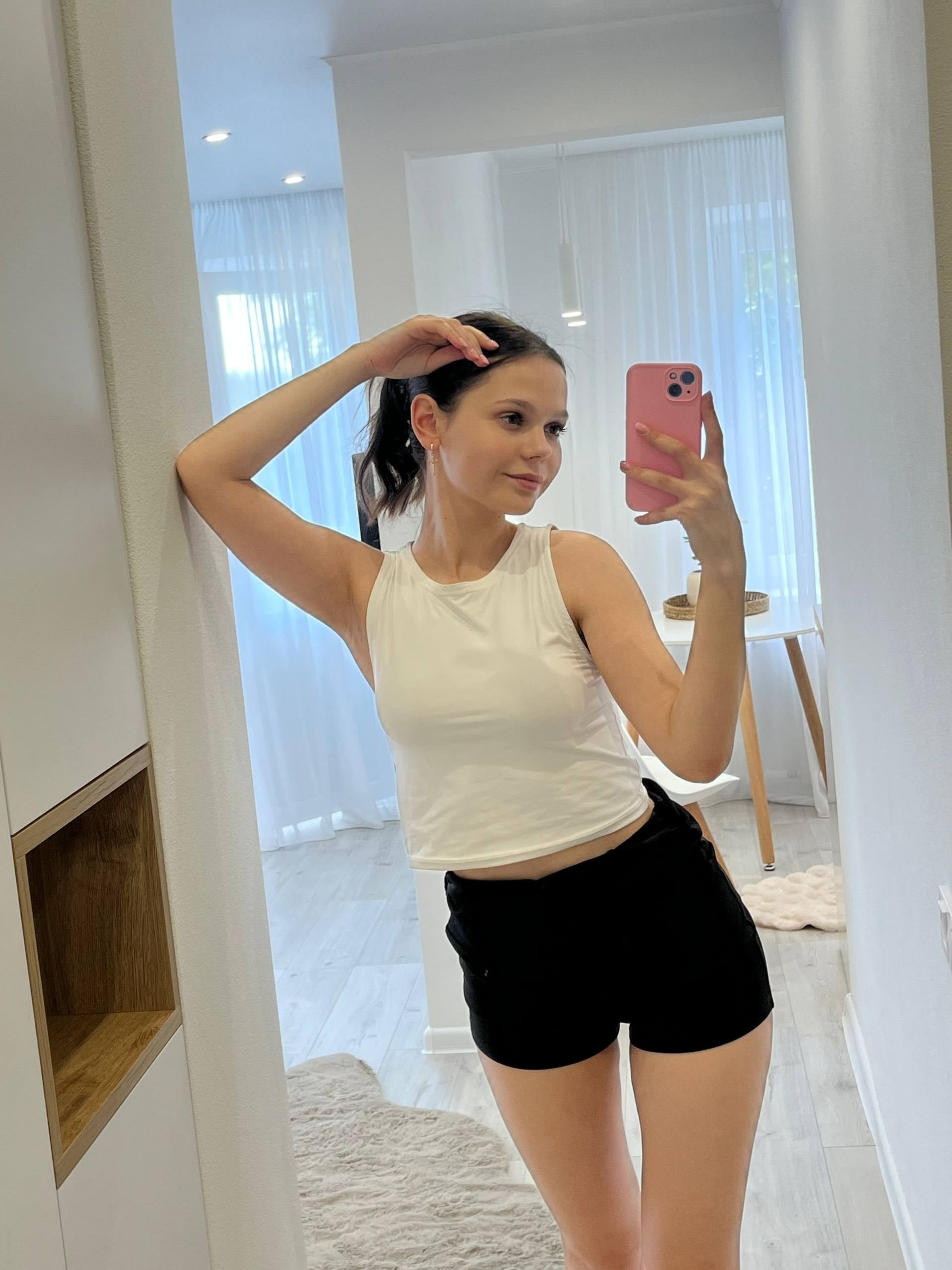 Young woman with large areolas frequently poses nude in various outfits – photo 1