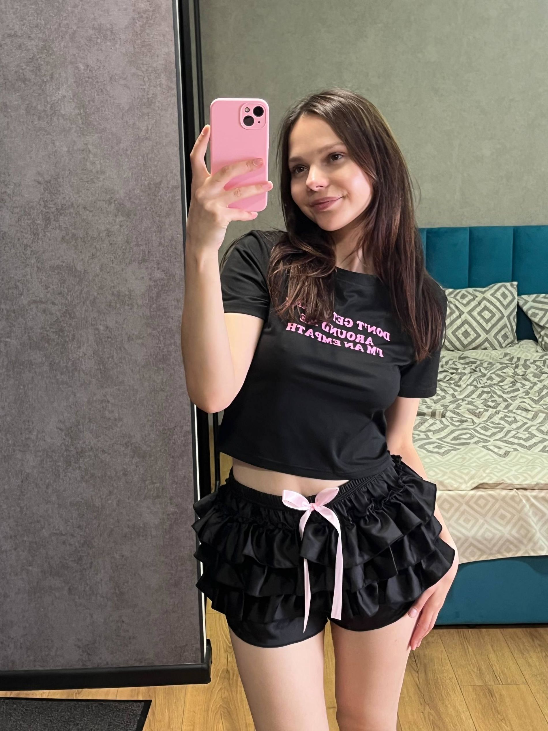 Young woman with large areolas frequently poses nude in various outfits