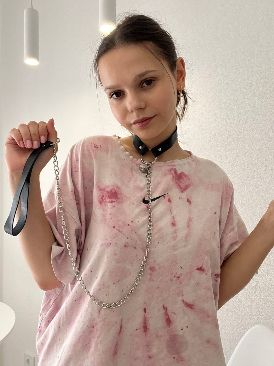 Young woman with large areolas frequently poses nude in various outfits