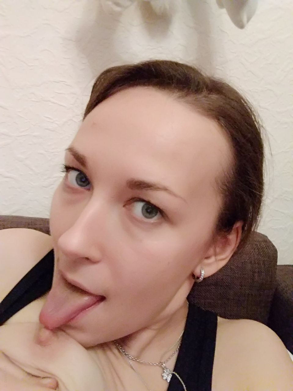 Naked Girl Takes Explicit Selfie, Revealing Intimate Body Parts in Cozy Setting