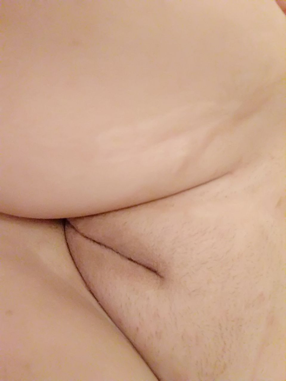 Naked Girl Takes Explicit Selfie, Revealing Intimate Body Parts in Cozy Setting