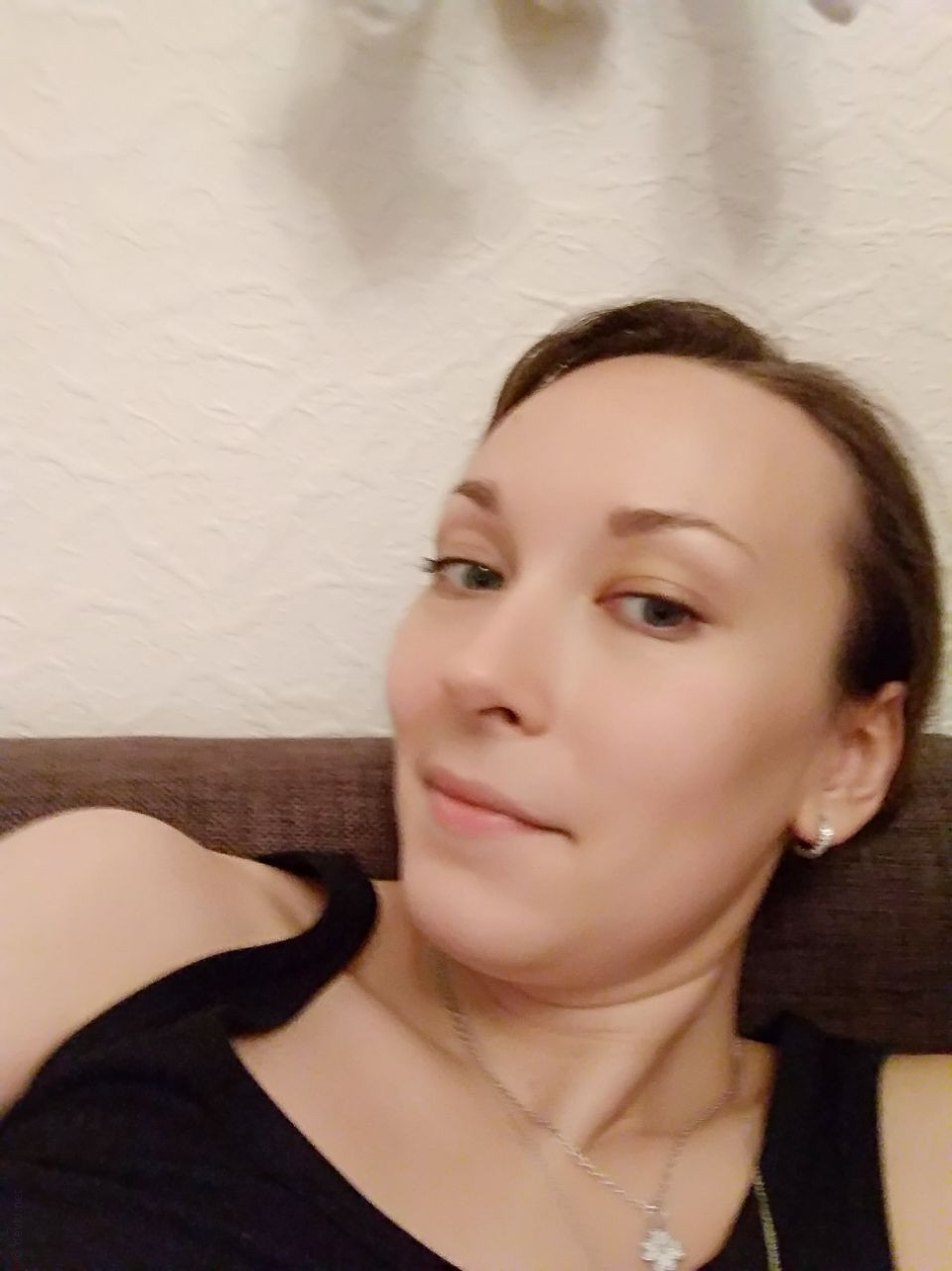 Naked Girl Takes Explicit Selfie, Revealing Intimate Body Parts in Cozy Setting