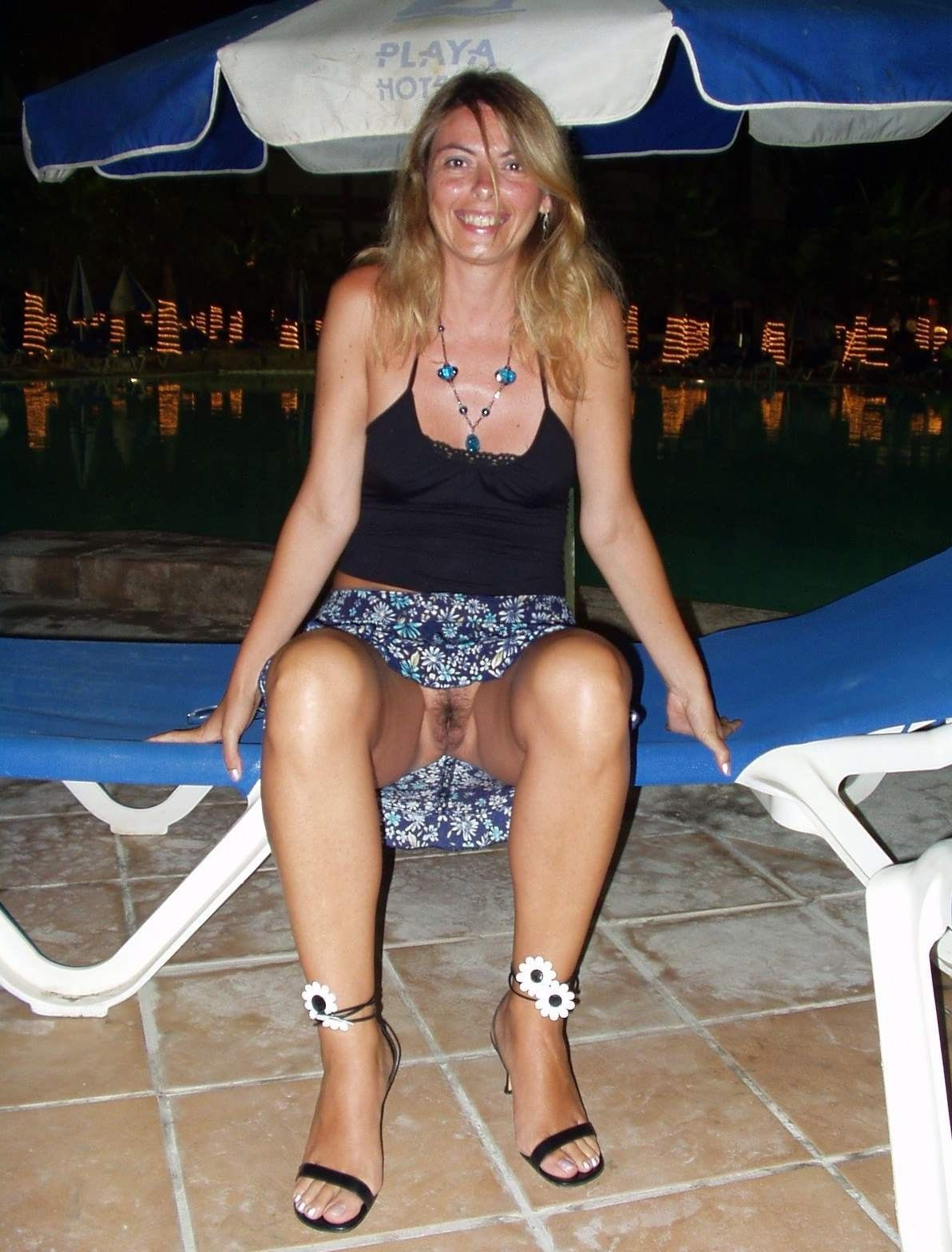 Sexy woman on vacation spreads her pussy wide on bed