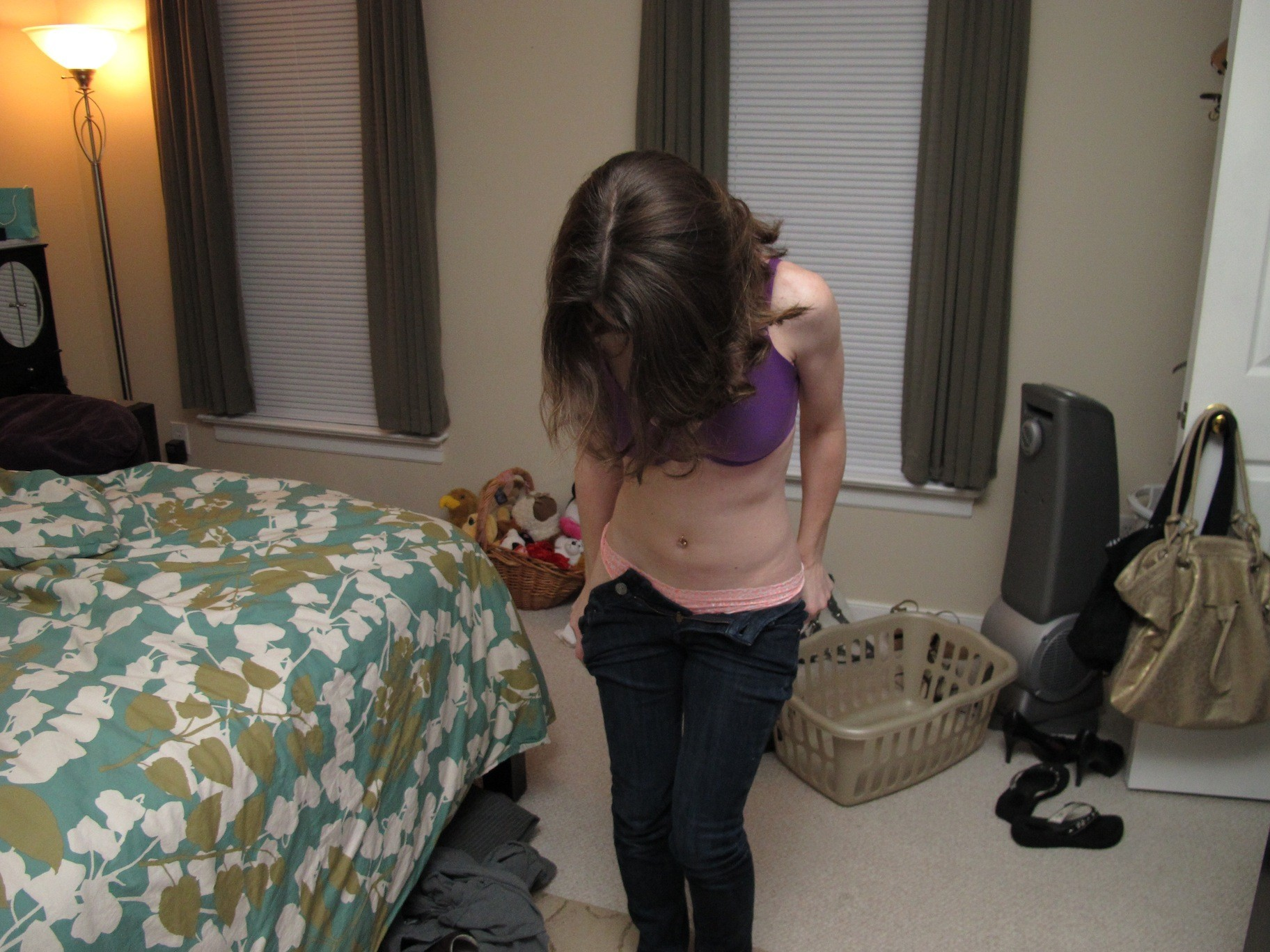 Seductive lady posing and spreading legs on bed