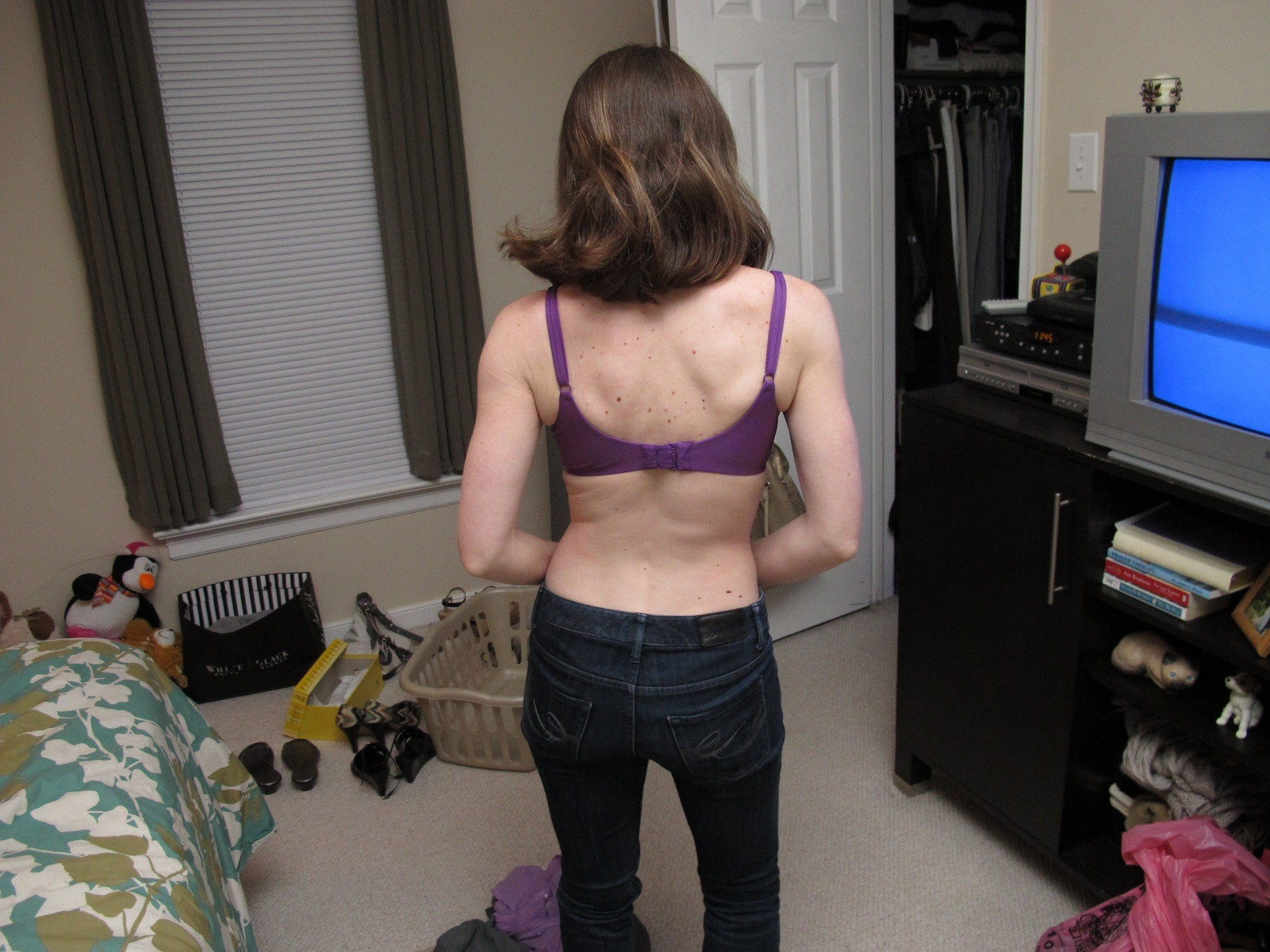 Seductive lady posing and spreading legs on bed