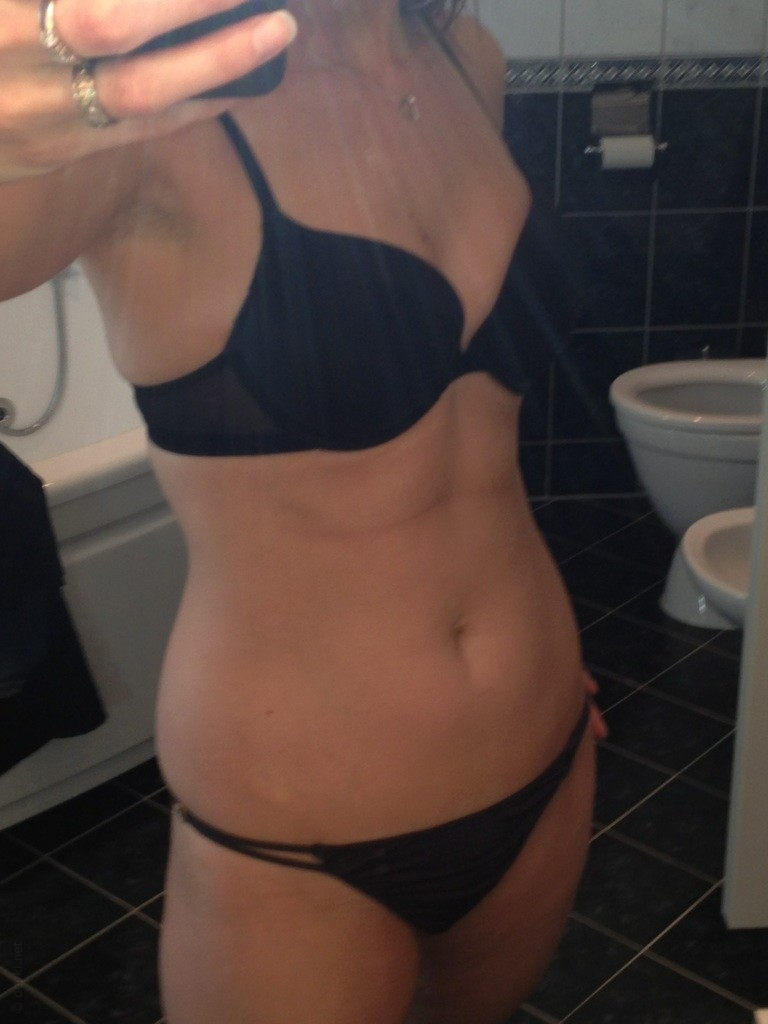 Sensual girl posing nude in hotel room during vacation