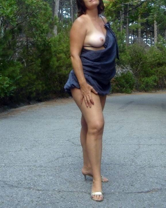 Hot mature woman looks incredibly sexy in the forest outdoors