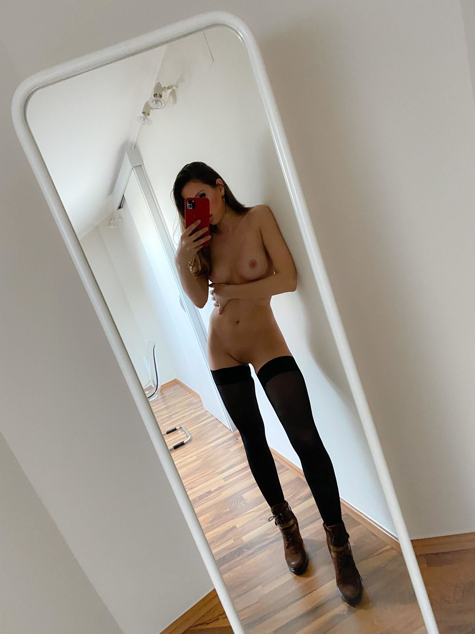 Sexy Young Woman Shows Off in Stockings and High Heels