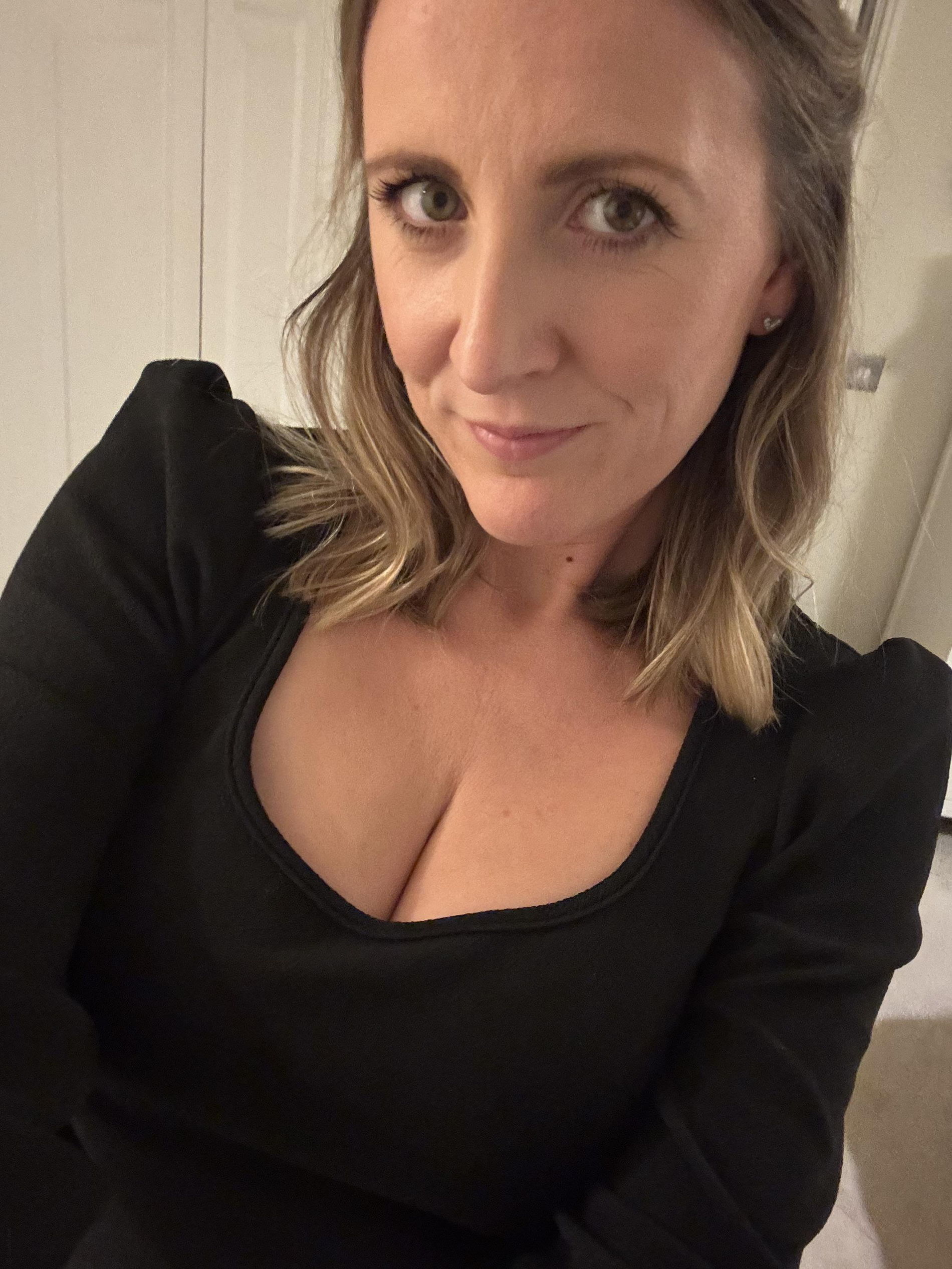 Seductive woman takes mirror selfie, capturing her reflection