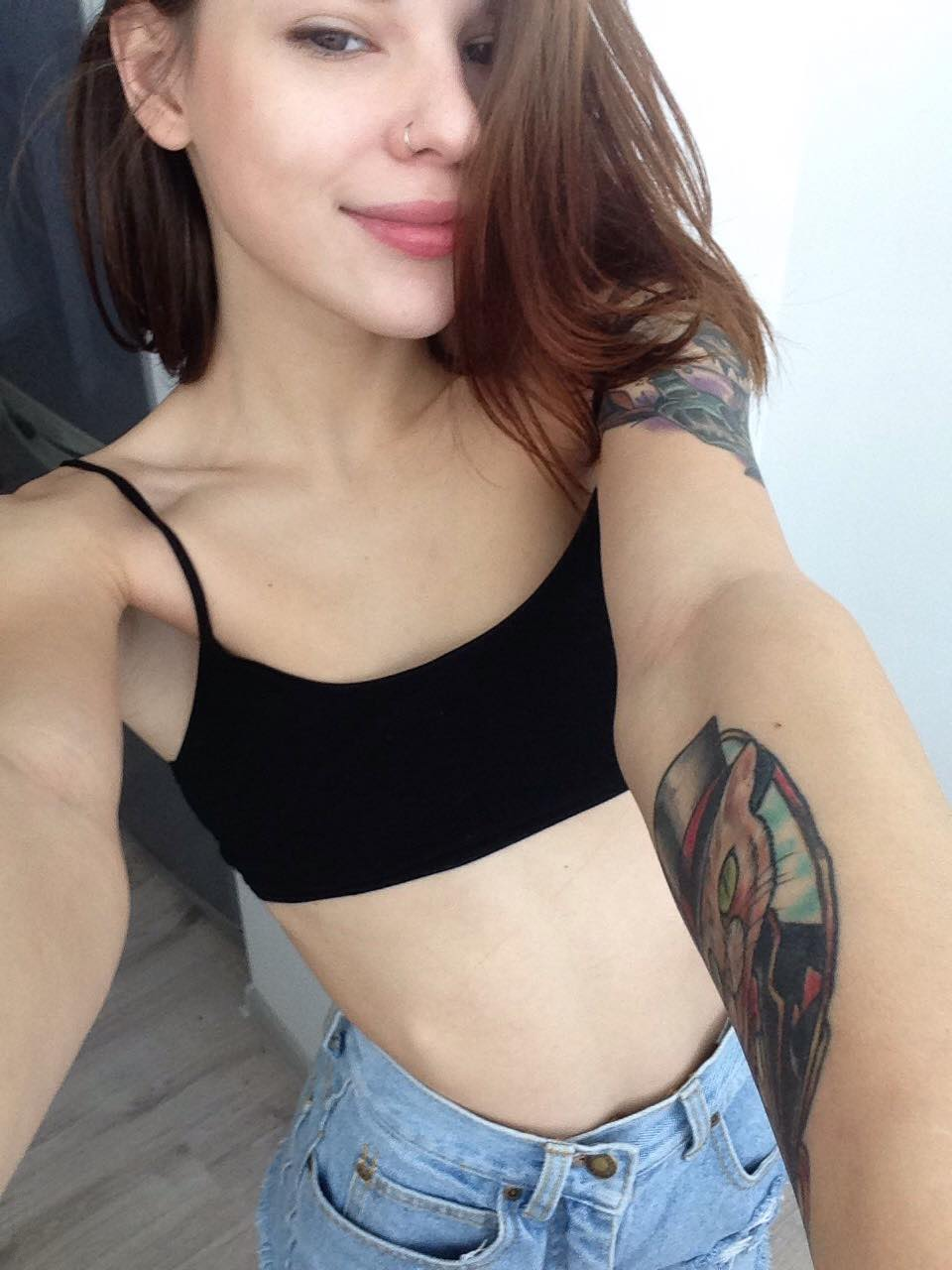 Young girl with tattoos having sex and showing intimate parts in porn photos